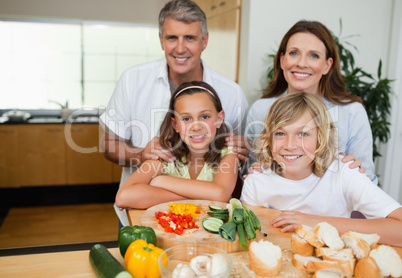 Cheerful family making sandwiches