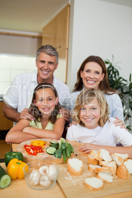 Happy family making sandwiches