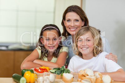 Siblings and mother making sandwiches