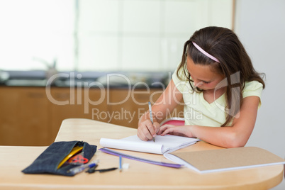 Girl doing homework in the kitchen