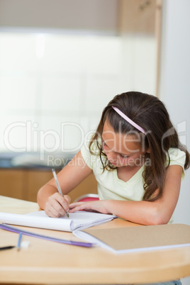 Girl writing in the kitchen