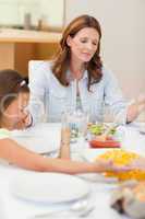 Praying family about to have dinner