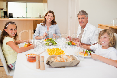 Smiling family having dinner