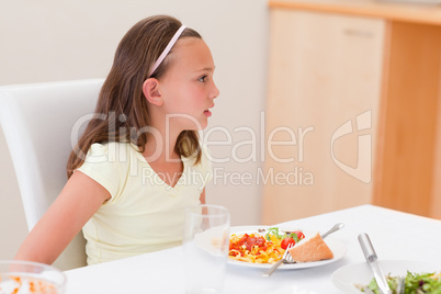 Girl with dinner at the table