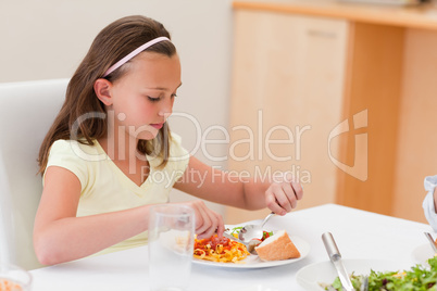 Girl having dinner at the table