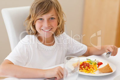 Smiling boy having dinner