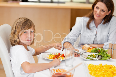 Side view of boy sitting at the dinner table