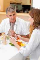 Man talking to wife during dinner