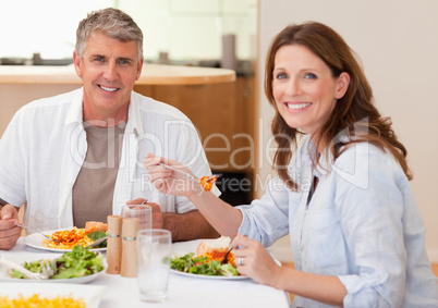 Smiling couple eating dinner