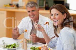 Laughing couple eating dinner