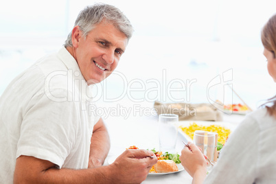 Side view of happy smiling man during dinner