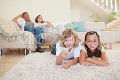 Siblings on the floor watching tv together