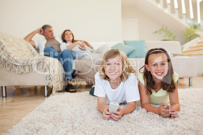 Siblings on the floor watching tv