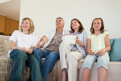 Family on the couch watching tv