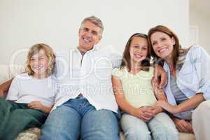 Happy family sitting on the sofa