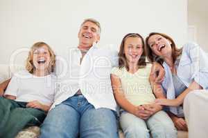Laughing family sitting on the sofa