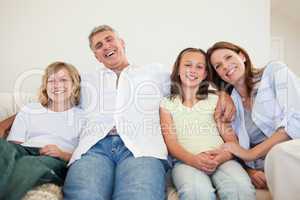 Laughing family sitting on the couch