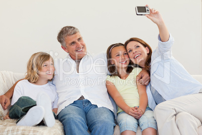 Mother taking a picture on the couch