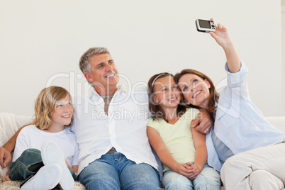 Mother taking a picture on the sofa