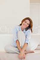 Smiling mature woman sitting on couch