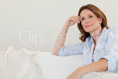 Mature woman in thoughts on couch