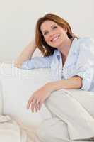 Smiling woman sitting on sofa