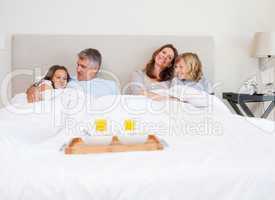 Family about to have breakfast in bed
