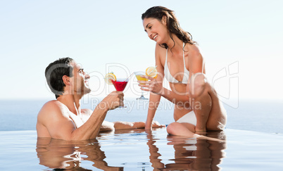Couple having cocktails in the pool