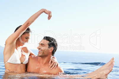 Happy couple enjoying time together in the pool