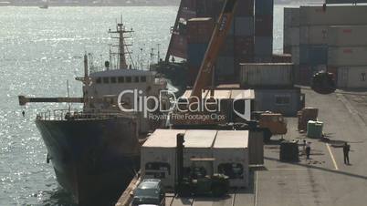 Crane Loads Cargo Onto Ship At Port