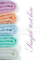 multicolor towels stacked on white background with area for your