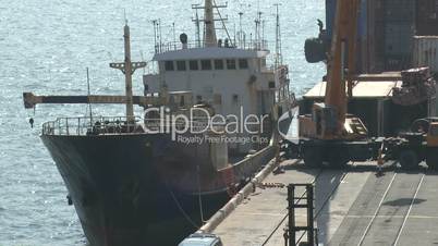 Crane Loads Cargo Onto Ship At Port