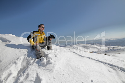 Man posing on mountain with camera