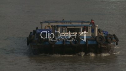 Barge Sails Up River Towards Camera