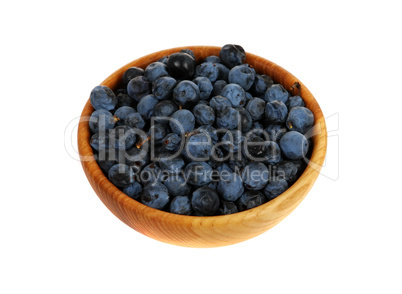 sloe, blackthorn in a wooden mortar (Prunus spinosa)