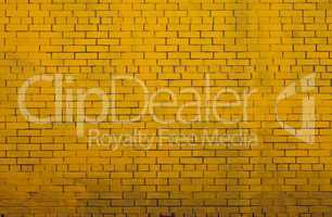 Background with old yellow painted brick wall
