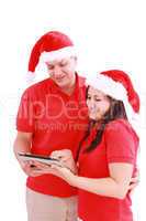 Happy Christmas couple looking a tablet computer. Isolated on wh