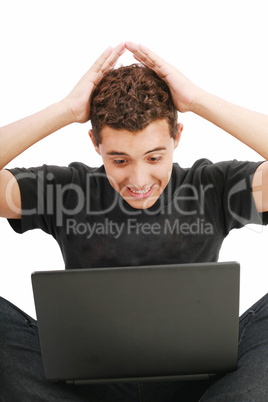 young man shocked with something he see on his laptop computer