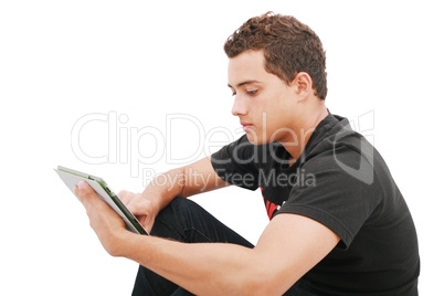 School boy with electronic tablet sitting in the floor