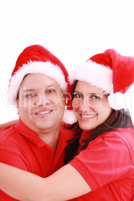 Young happy couple near with Santa hats. Isolated over white bac