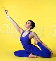 Woman doing yoga split in blue on yellow