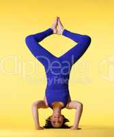 happy woman head stand blue on yellow