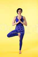 woman stand on one leg in yoga pose