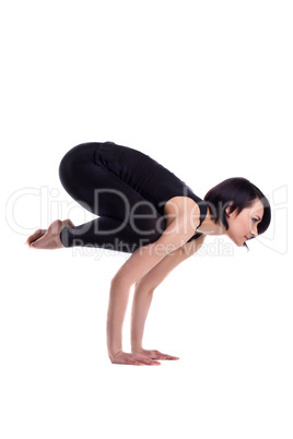 young woman doing arm balance yoga