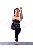 young woman stand in yoga pose on rubber mat