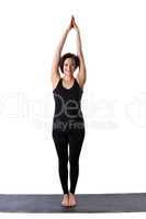 woman stand on rubber mat in yoga pose