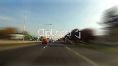 Car driving time laps thru cityscape