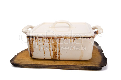 Dirty ceramic pot for stove on old kitchen board