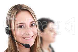 Beautiful representative smiling call center woman with headset.