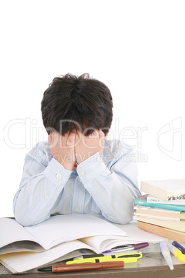 Stressed schoolboy studying in classroom